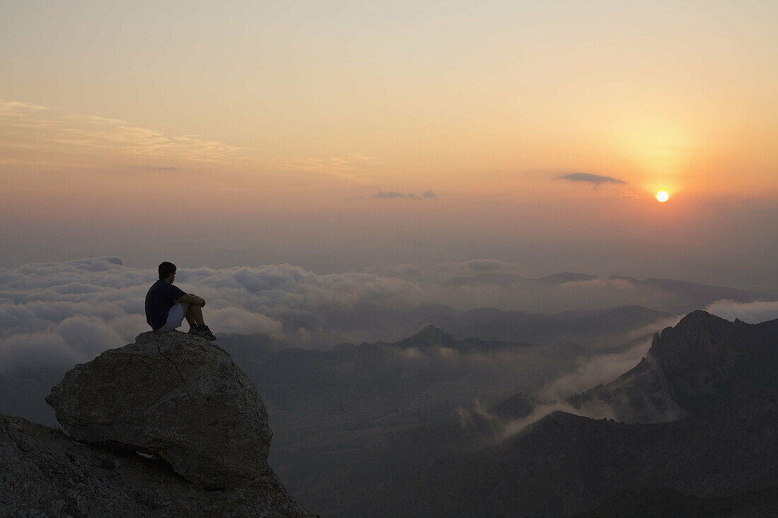 Hiker on the top of Maigmó mountains in the evening. Alicante province, Comunidad Valenciana, Spain