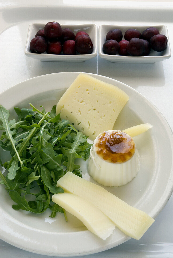 Cheeses with lemon jam, rocket and cherries.