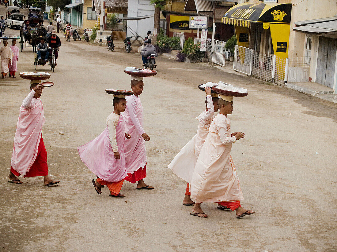 Nuns walking on their morning alms rounds in the old city of Bagan in Myanmar