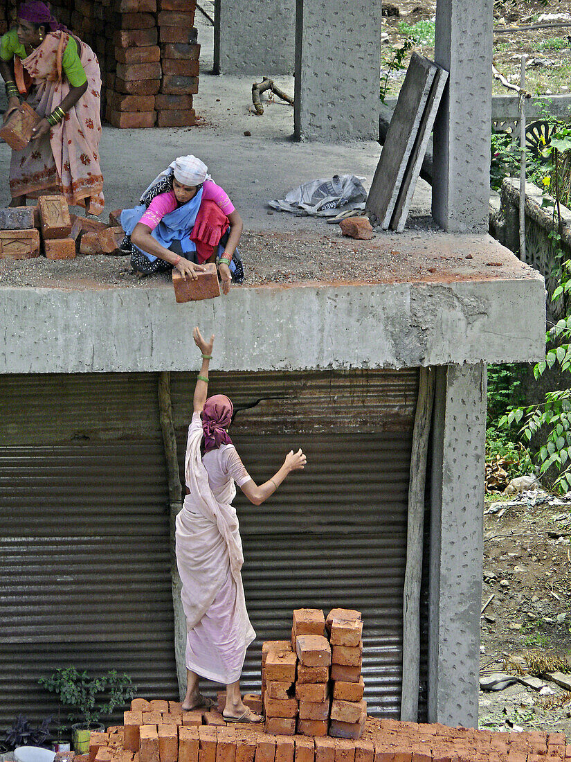 Women are working on construction of a building. Pune, Maharashtra, India.