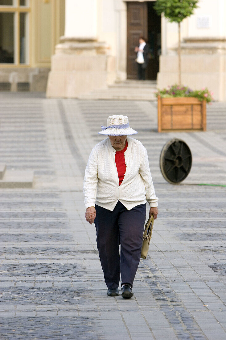 Center, Color, Colour, Contemporary, Cultural, Europe, Large, Medieval, Old, Paved, Romania, Square, Stones, Walking, Woman, T89-626483, agefotostock