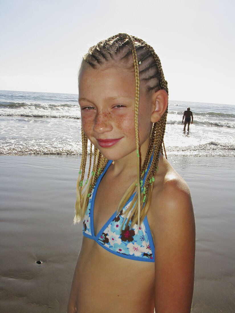 Young girl with dreadlocks on a beach