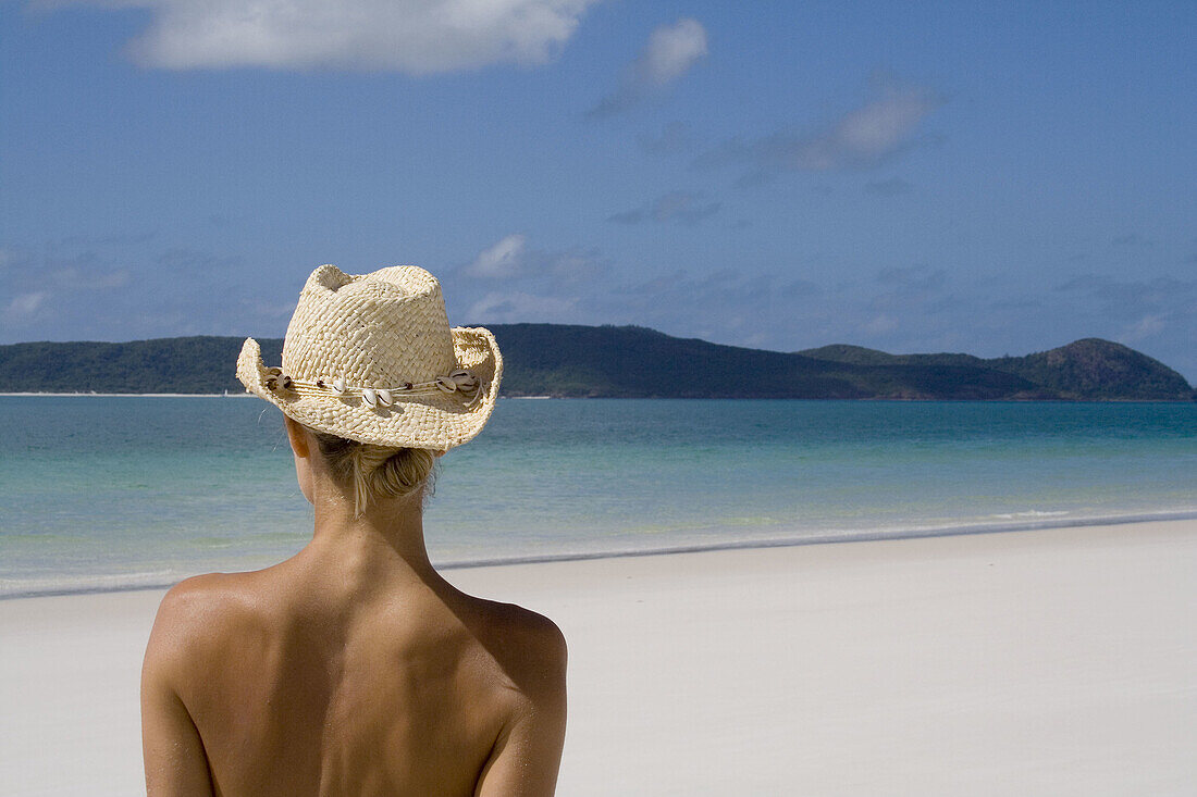 Back of a woman wearing a cowboy hat, Whitehaven Beach, Australia.