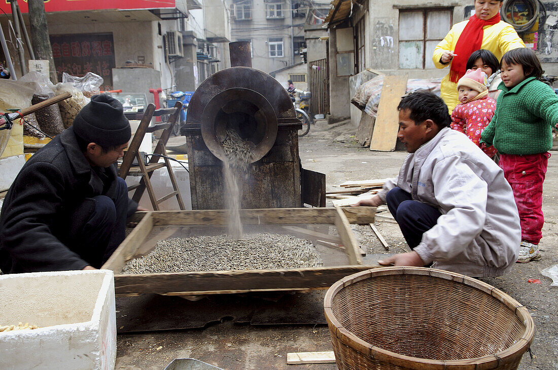 Roasting the sunflower seeds in a small street market in Nanjing, China