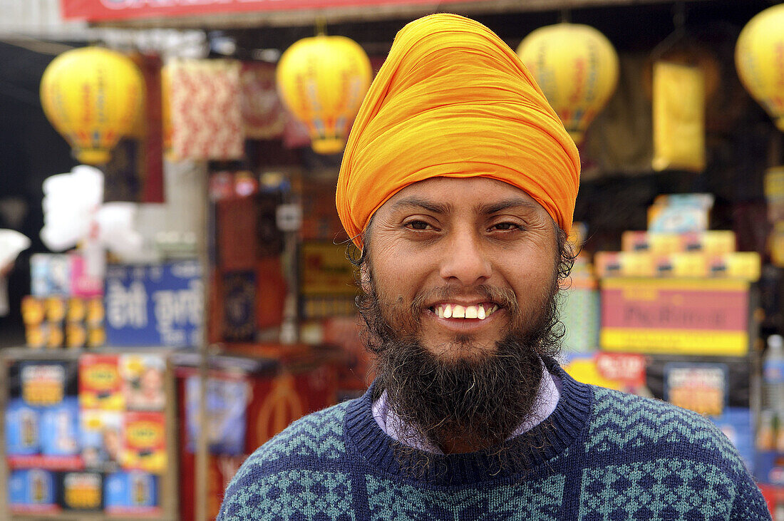 A friendly Sikh man smiles to the camera