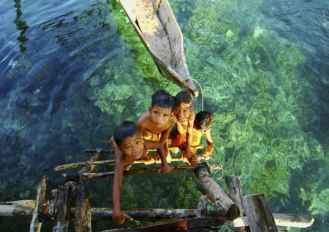 Bajau children (sea gypsies), nomads of the Indonesian seas. They live in boats and keep houses in steady places where they spend the rainy season. Indonesia.