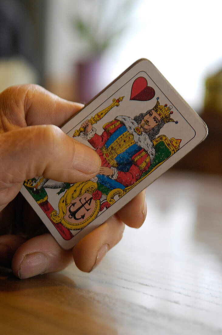Hand holding playing card, South Tyrol, Italy, Europe