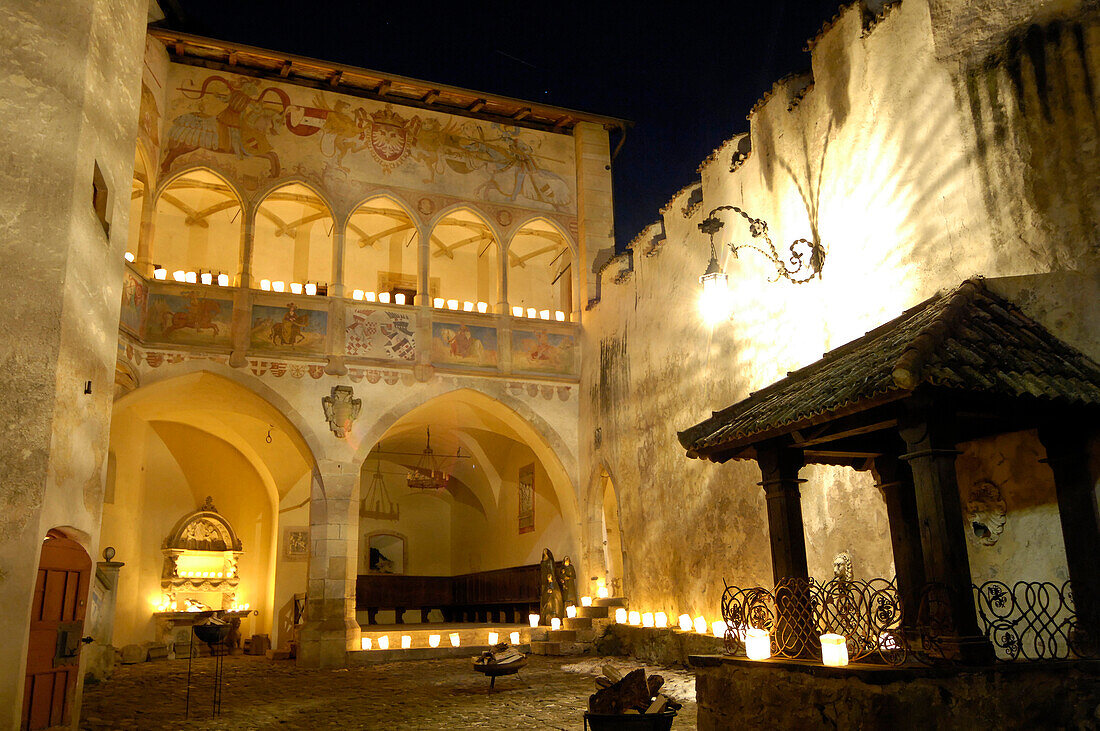 The illuminated atrium of castle Prösels at night, Völs am Schlern, South Tyrol, Italy, Europe