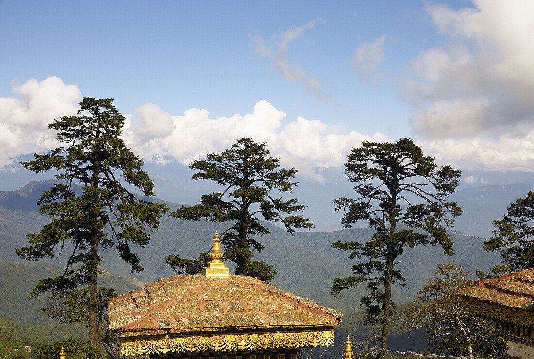 A stupa roof in Bhutan looks out over the Himalayian foothills