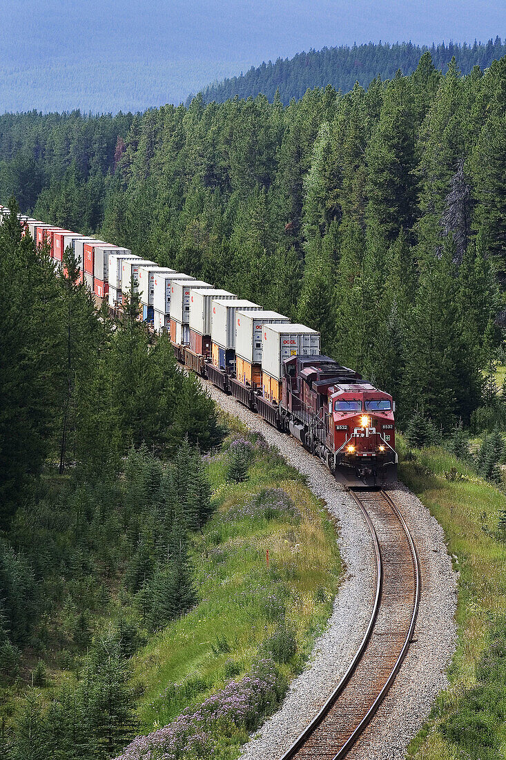A Canadian Pacific intermodal train, or stack train, heading east through Banff National Park in Alberta, Canada.