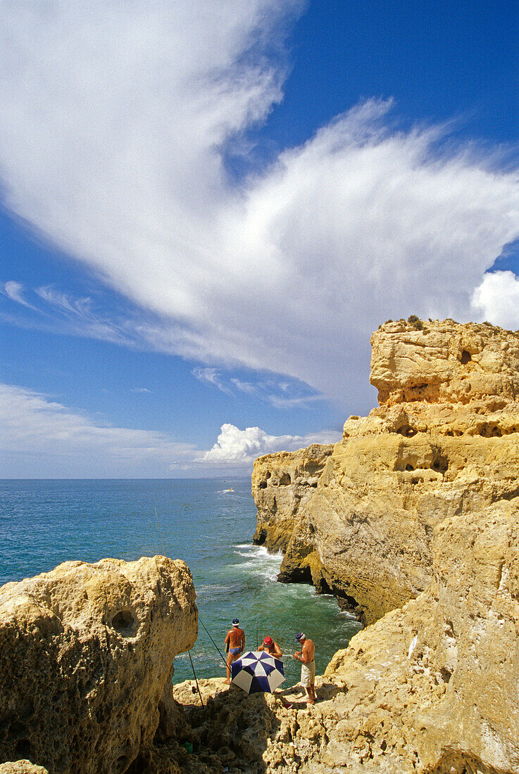 Anglers at the rocky coast in the sunlight, Algar Seco, Algarve, Portugal, Europe