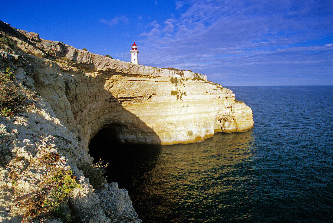 Lighthouse at the rocky coast in the sunlight, Praia do Carvalho, Algarve, Portugal, Europe