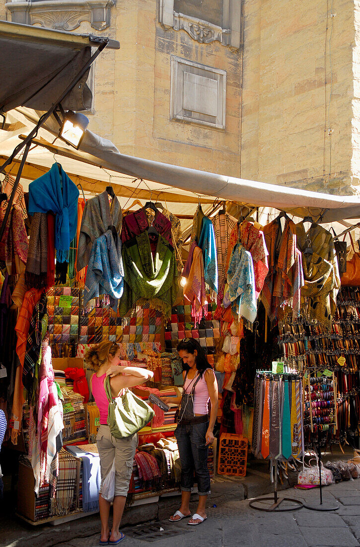 Two women at a market stand at Mercato San Lorenzo, Florence, Tuscany, Italy, Europe