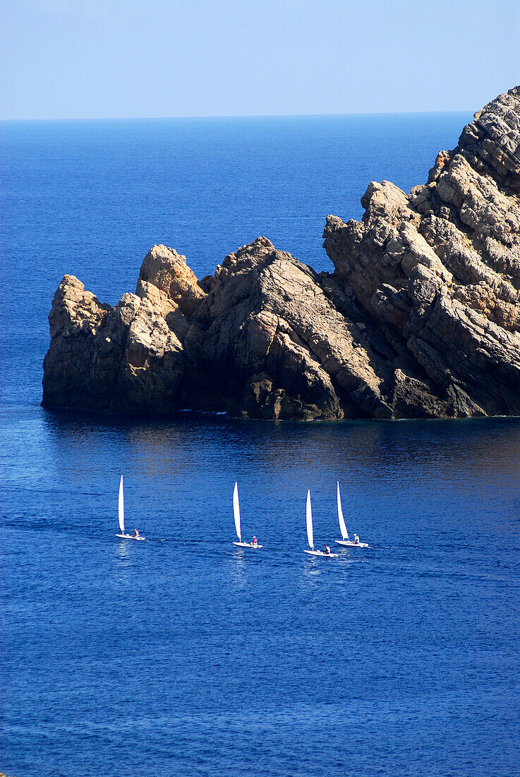 Sailing boats from a sailing school from Fornells at Cap de Fornells, Minorca, Balearic Islands, Spain