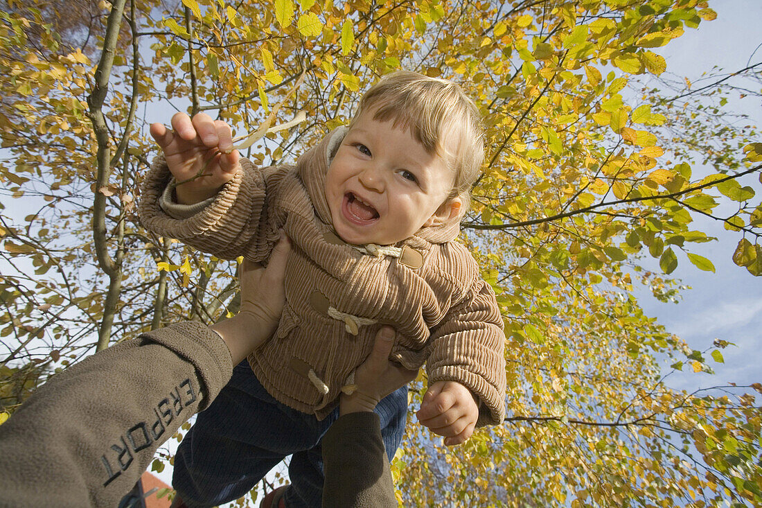 Child lifted up, München, Bavaria, Germany