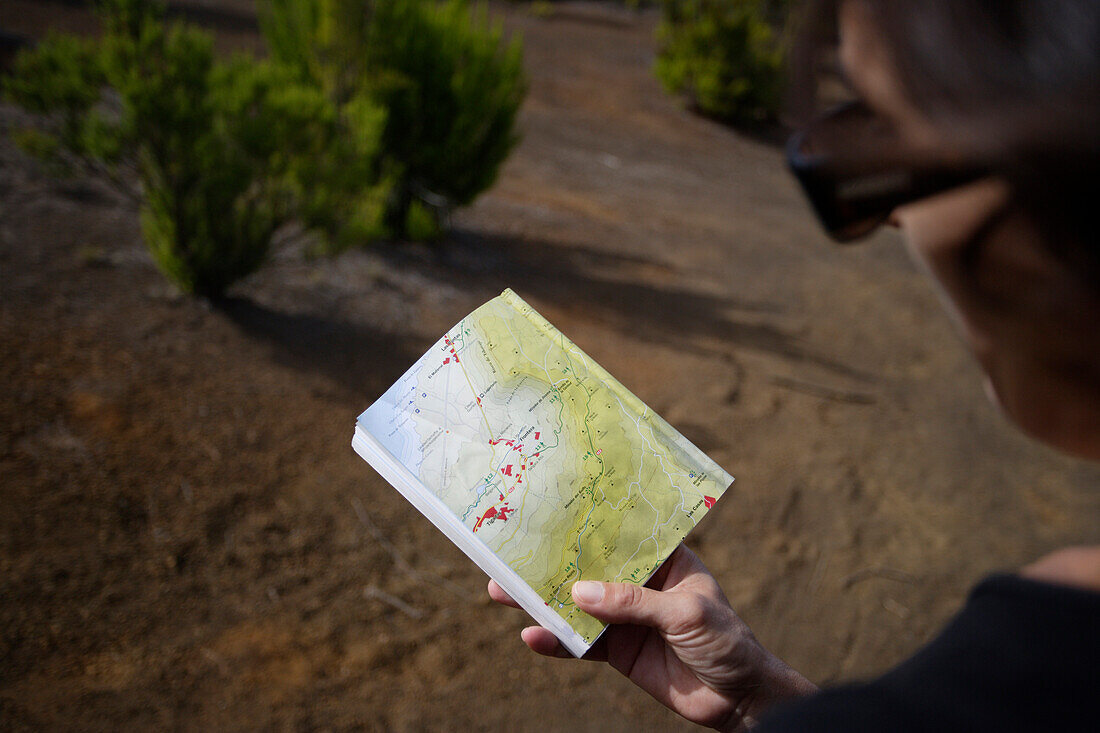 Hiker looking at a map, Camino de la Virgin, Malpaso, El Hierro, Canary Islands, Spain