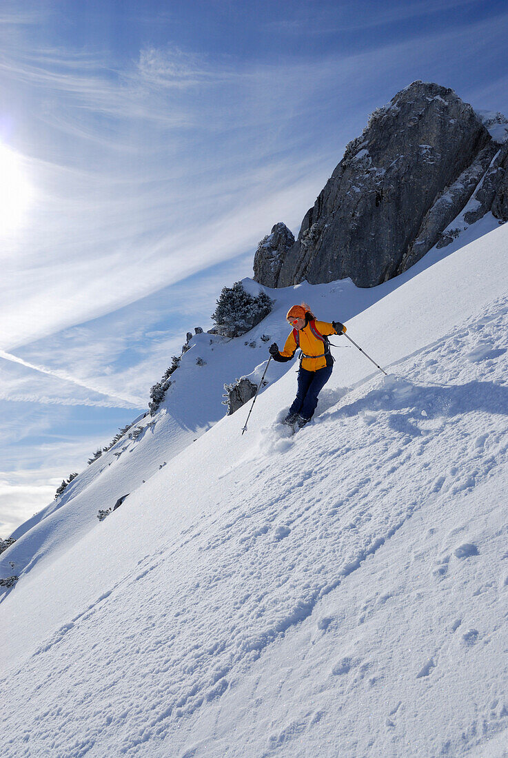 Woman downhill skiing in powder snow, Lacherspitze, Mangfall range, Bavaria, Germany