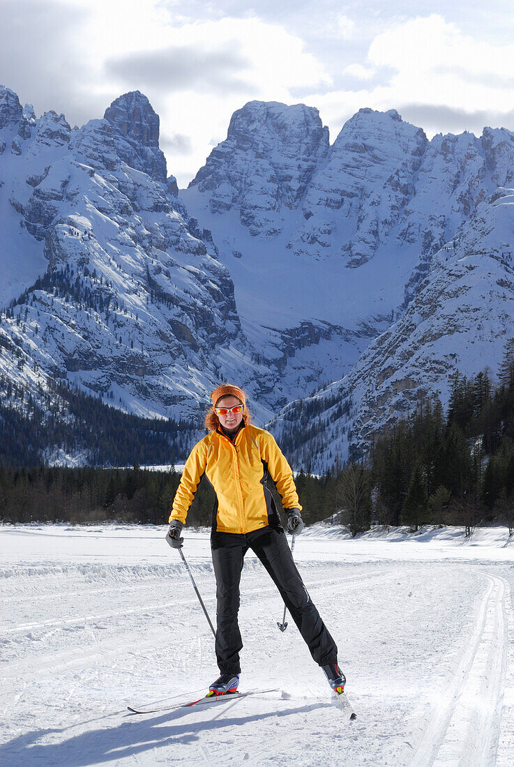 Woman cross-country skiing, lake Duerrensee, Cristallo range, Dolomites, South Tyrol, Italy