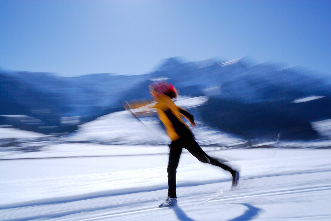 Woman cross-country skiing, Walchsee, Kaiser range, Tyrol, Austria