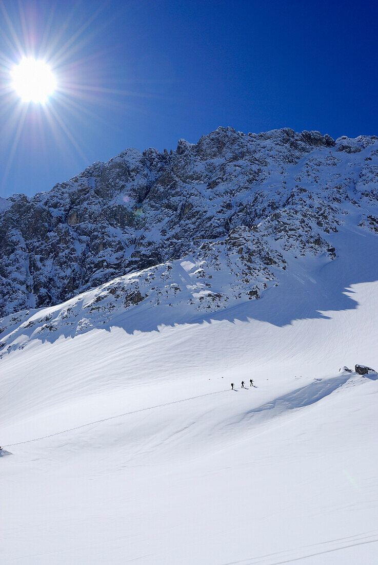 Three backcountry skiers ascending, Tajatoerl, Mieminger range, Tyrol, Austria