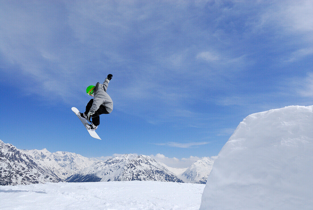 Snowboarder jumping from a kicker, ski area Soelden, Oetztal, Tyrol, Austria