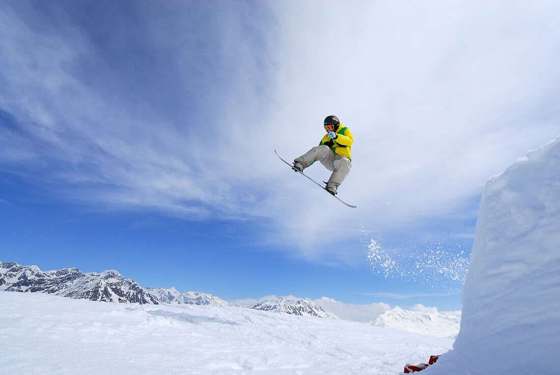 Snowboarder jumping from a kicker, ski area Soelden, Oetztal, Tyrol, Austria