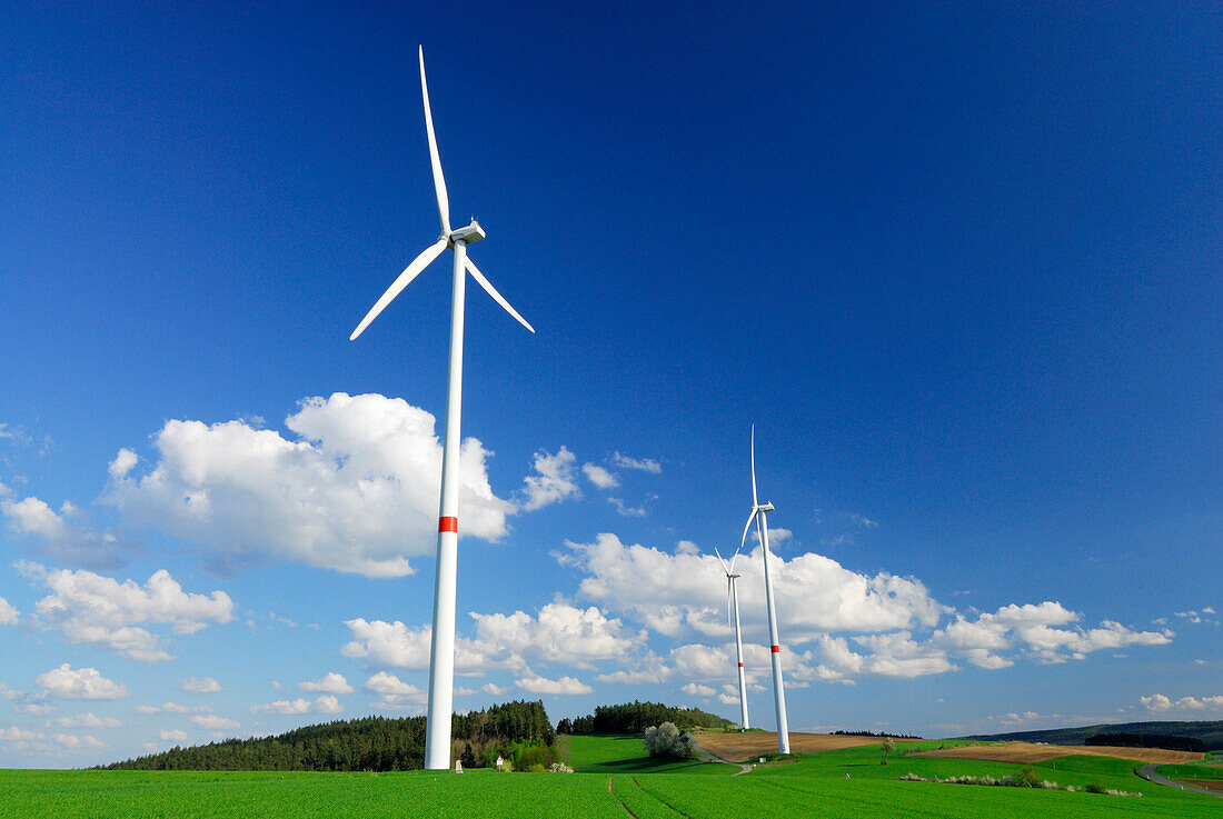 Three wind turbines in meadow, Bavaria, Germany