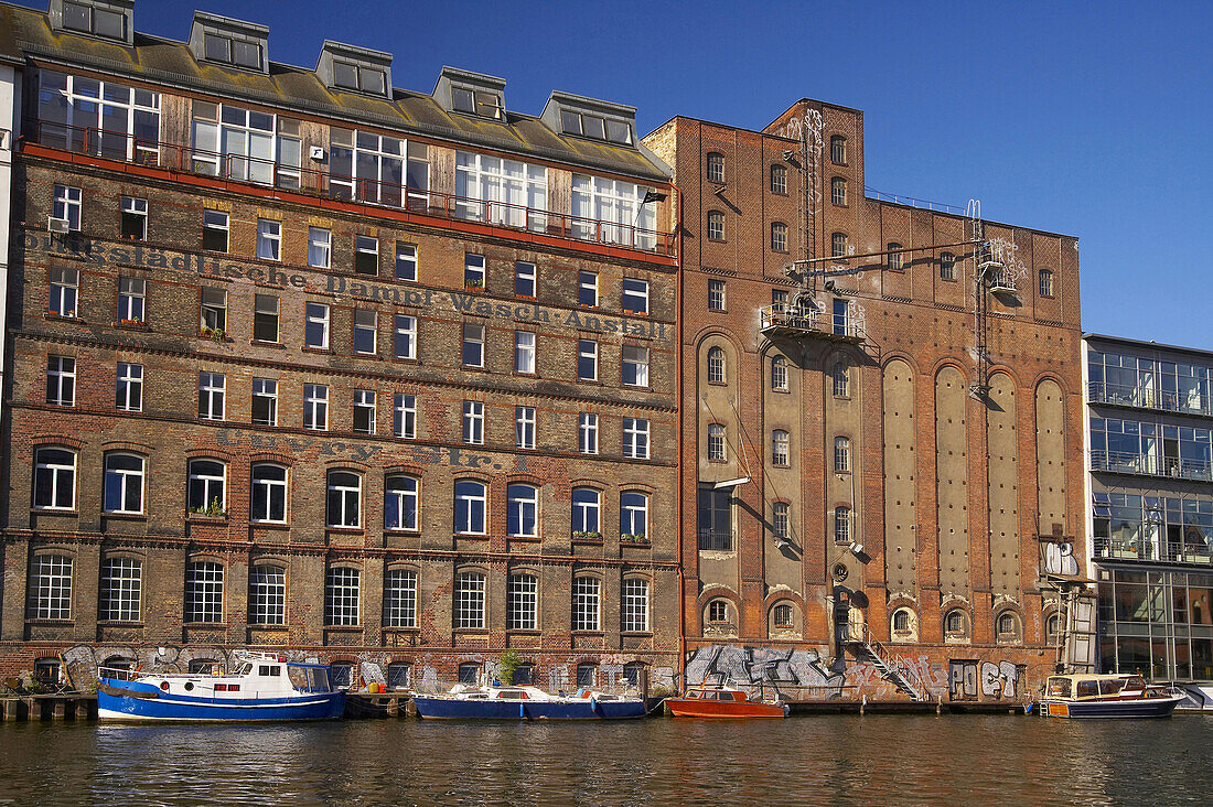 Old-fashioned red brick buildings at river Spree near Osthafen, Berlin, Germany