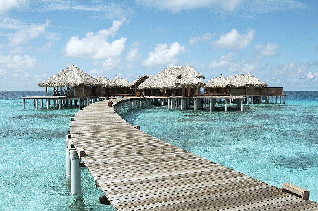 Board walk guiding to bungalows. Maldives Island, Indian Ocean.