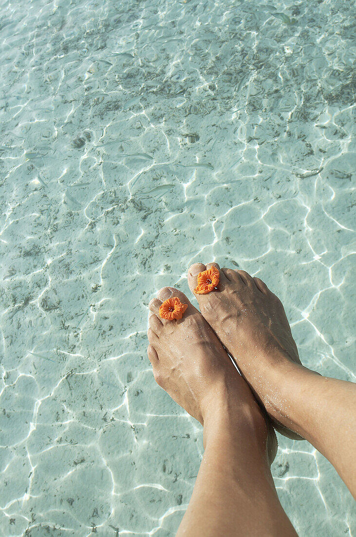 Man feet at Indian Ocean, Maldives Island.