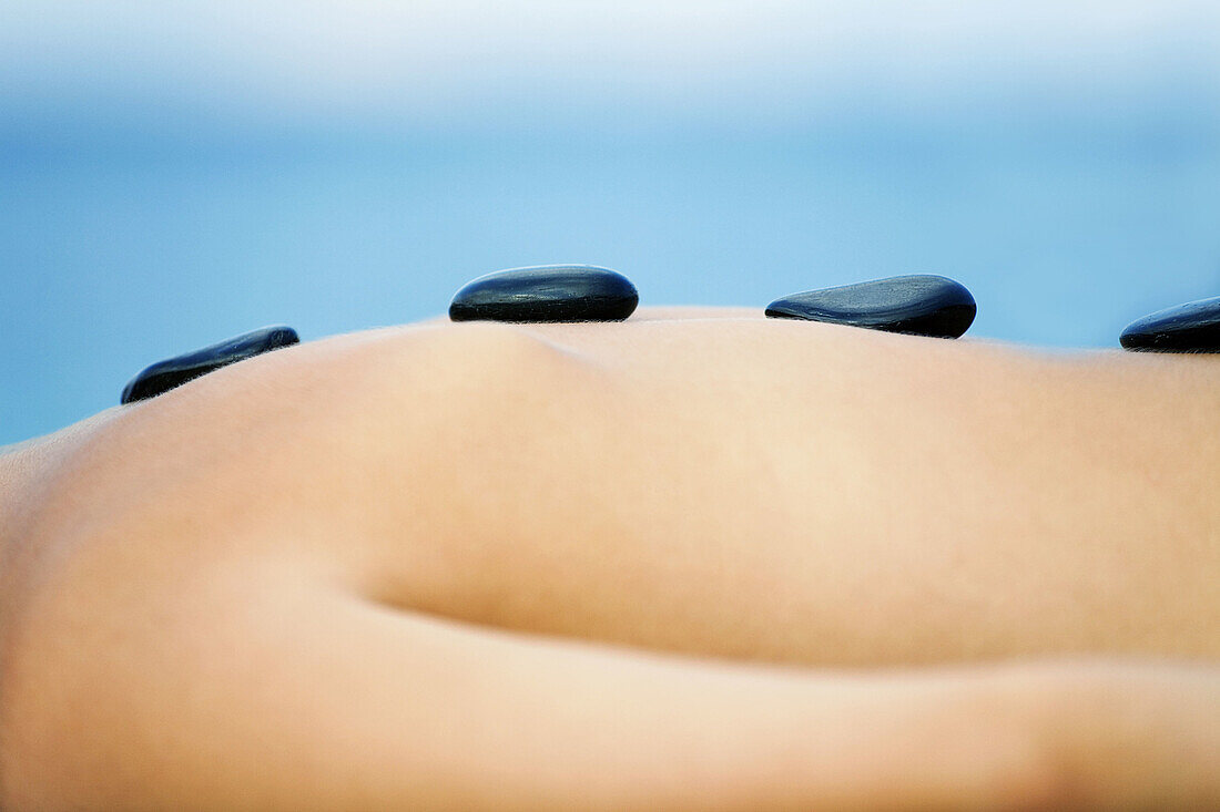 Detail of a woman having a massage by the sea