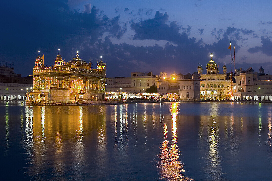 Sikh Golden Temple of Amritsar glowing at dusk, Punjab, India