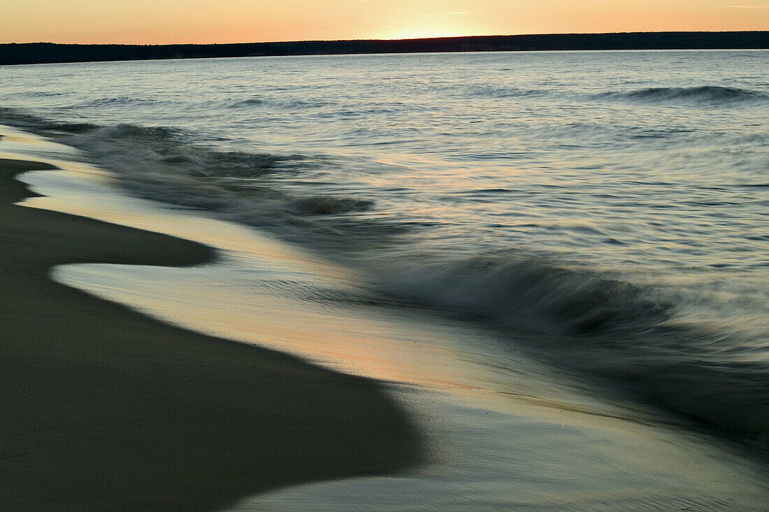 Breaking waves at sunset on the shores of Lake Superior, Upper Peninsula of Michigan, USA