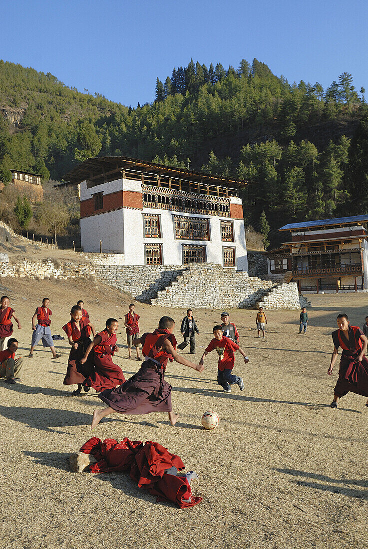 Buddhist novices playing football, paro dzong, Bhutan