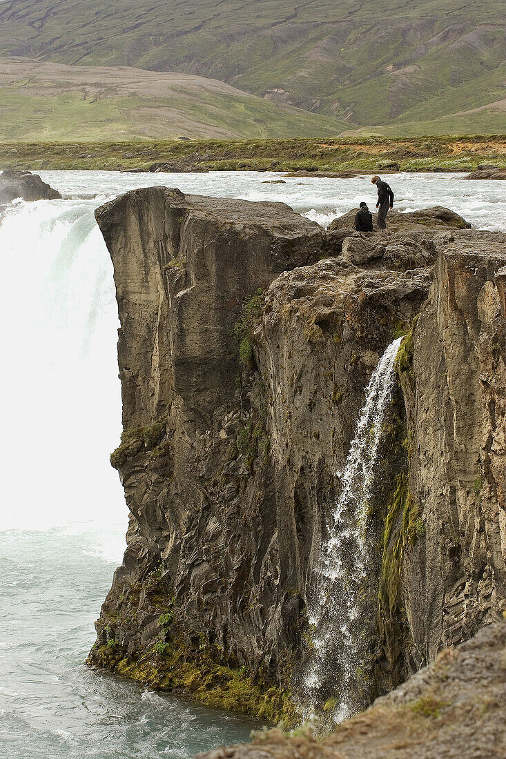 Hiking around the rocks that form Goðafoss waterfall in Northern Iceland