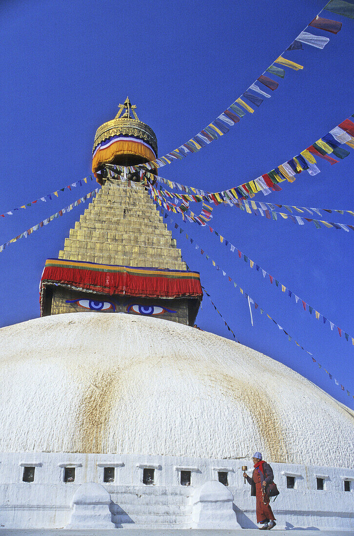 Nepal, Kathmandu, the Bodhnath Stupa, Tibetan Buddhist with prayer wheel