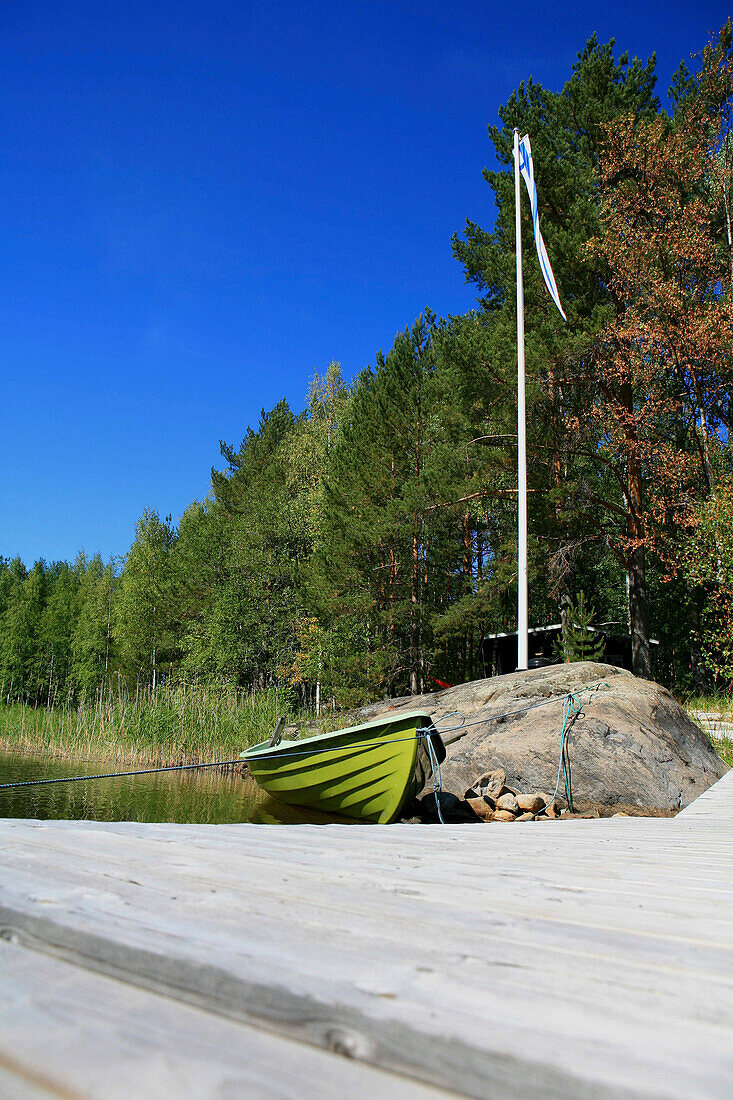Boat at a jetty in a bay of Lake Saimaa, Saimaa Lake District, Finland, Europe