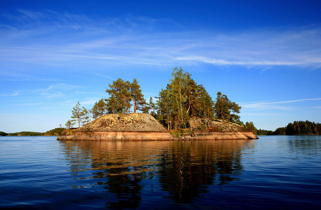 Private island with trees under blue sky, Saimaa Lake District, Finland, Europe
