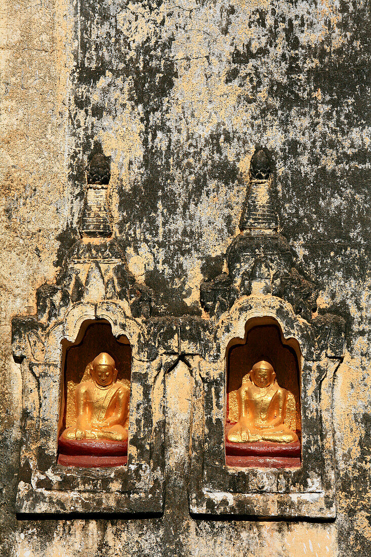 View at little golden Buddha statues in a temple wall, Bagan, Myanmar, Burma, Asia