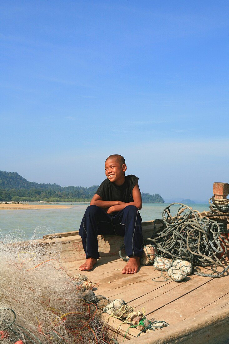 Sea gypsy, Moken boy on a fishing boat, Mergui Archipelago, Andaman Sea, Myanmar, Burma, Asia