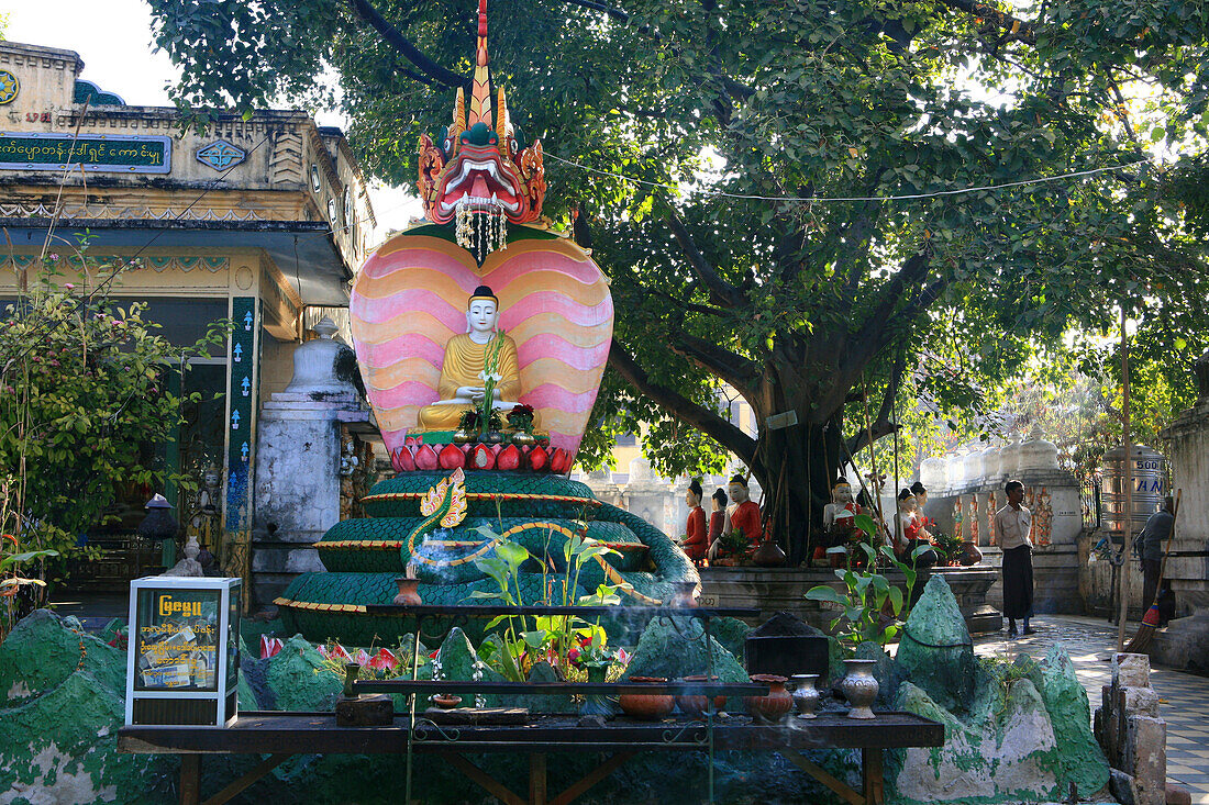 Buddha statue and people at the Shwekyimyint Pagoda in the morning, Mandalay, Myanmar, Burma, Asia