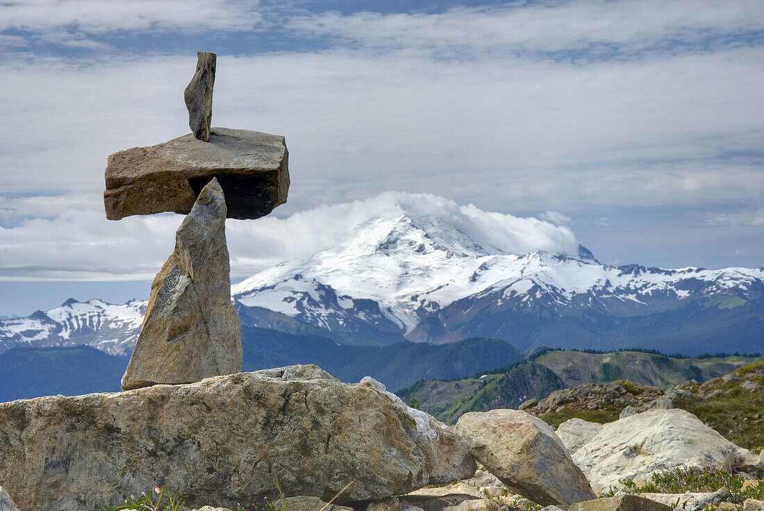 Rock cairn on the slopes of Tomyhoi Mountain Mount Baker Wilderness Washington, Mount Baker 3286 meters 10781 feet is in the distance