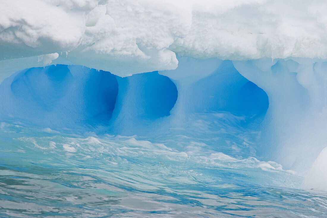 Whimsical ice caves formed by wind and sea in this iceberg detail in and around the Antarctic Peninsula during the summer months  More icebergs are being created as global warming is causing the breakup of major ice shelves and glaciers