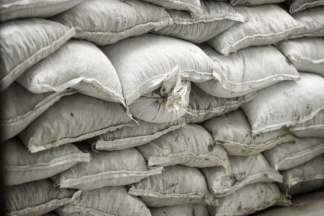 Stacked construction white sand bags
