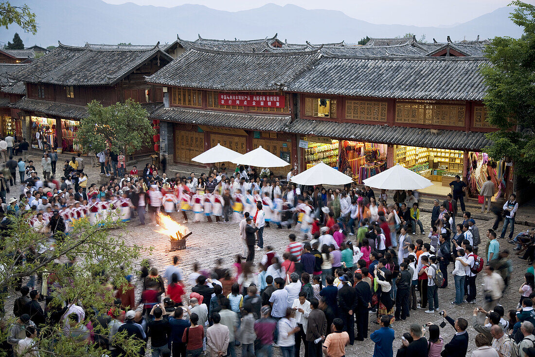China  Yunnan Province  Lijiang  The Old Town  Naxi minority women dancing in Sifang Square
