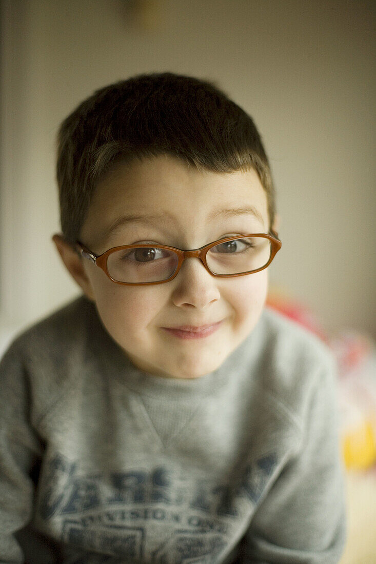 Smiling boy with eye glasses.