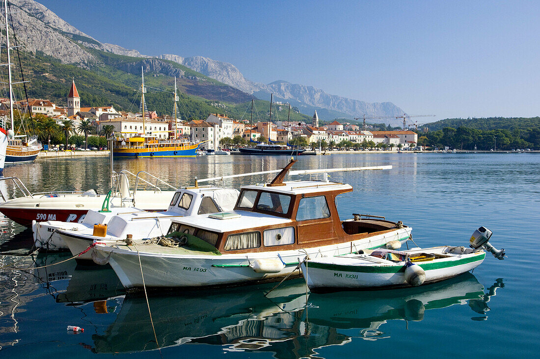 The harbour with a waterfront walk and fishing boats in Makarska, Croatia
