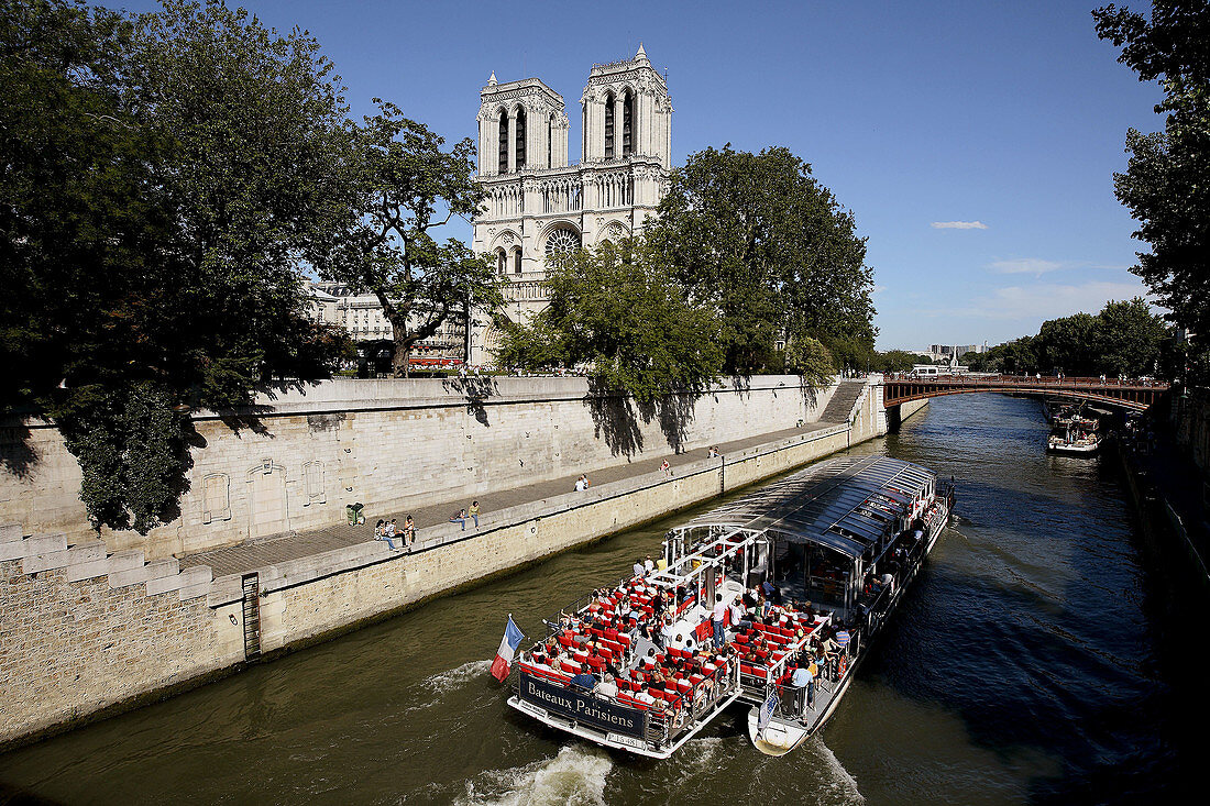 France. Paris. Tour boat in River Seine with Notre_Dame Cathedral in the background.