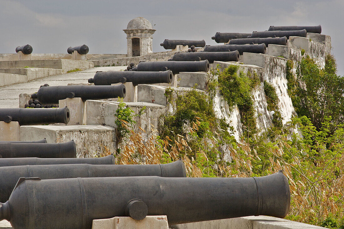 Piles of canon balls behind a row of canons at the Parque Historico Militar Morro-Cabana.