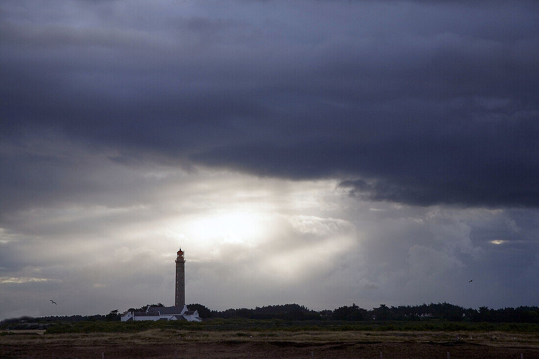 Brittany, Belle-Ile: large lighthouse  under the cloudy sky